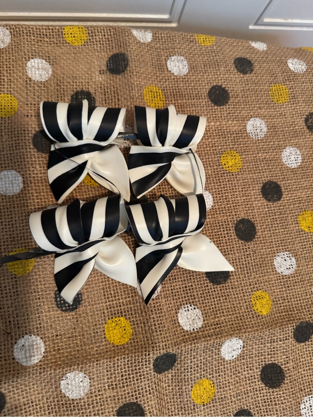 4 Black and White Striped Ribbon Napkin Rings plus 4 black chargers